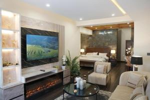 a large living room with a bed and a fireplace at ZAR Luxury Suites in Murree