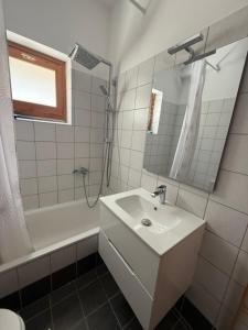 a white bathroom with a sink and a shower at Villa Pantazi in Riglia
