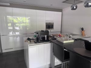 a kitchen with white cabinets and a black counter top at logies 2460 in Kasterlee