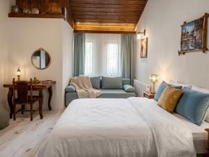 a bedroom with a bed and a table and a chair at Костовският хан in Chepelare
