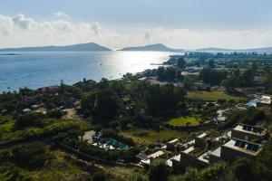 an aerial view of a small town next to the water at Gialova Hills - Luxury Villa with Private Pool, Sauna, Garden & Seaview in Gialova +45 photos
