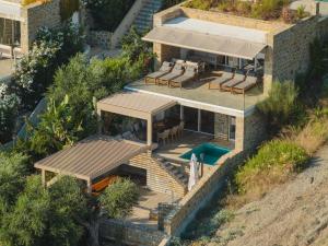 an aerial view of a house with a swimming pool at Gialova Hills - Luxury Villa with Private Pool, Sauna, Garden & Seaview in Gialova