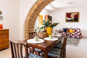 a dining room with a wooden table and chairs at Casa Bottega in San Salvo