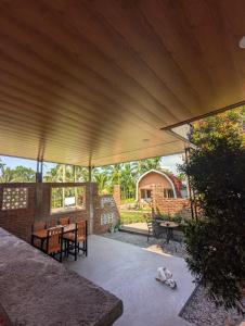 a pavilion with a table and chairs on a patio at Jati Rinjani Tetebatu in Tetebatu