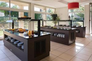 a kitchen with a buffet of food on display at Appartement T3 Golf Albret in Barbaste