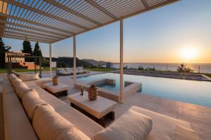a living room with a couch and a swimming pool at Monte Smith Luxury Villas in Rhodes Town