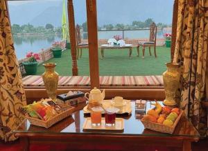a table with food and drinks on a balcony at Floating Luxury Group Of Houseboats in Srinagar