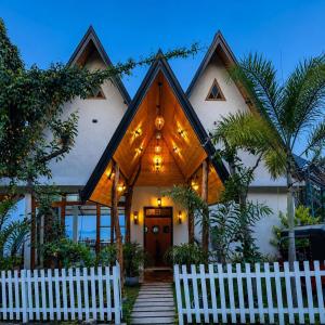 a house with a white fence in front of it at Eagle View villa in Ella