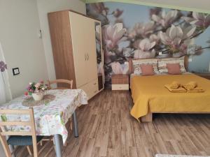 a bedroom with a bed and a flower mural at Rooms Katarina in Poreč