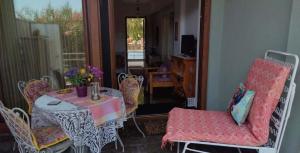 a room with a table and chairs and a balcony at AVRA House in Karfas