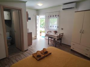 a living room with a table and a kitchen at Rooms Katarina in Poreč