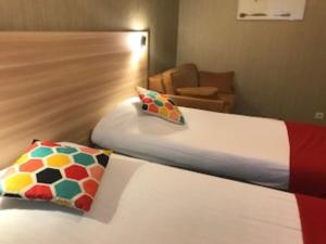 a hotel room with a bed and a chair at Auberge De Moricq in Angles