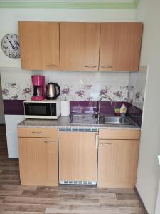 a small kitchen with a sink and a microwave at Rooms Katarina in Poreč +82 photos