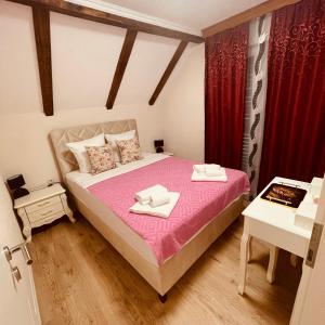a bedroom with a bed with two towels on it at Bela & Mare in Blace