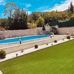 a swimming pool in a yard with green grass at Bela & Mare in Blace +11 photos