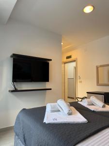 a bedroom with two beds and a flat screen tv at Apartments Vé in Budva