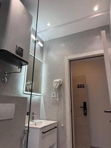 a small bathroom with a sink and a mirror at Apartments Vé in Budva +6 photos
