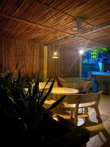 a dining room with a table and chairs and a table and a plant at Nhà Yên Homestay Phan Rang in Kinh Dinh +5 photos