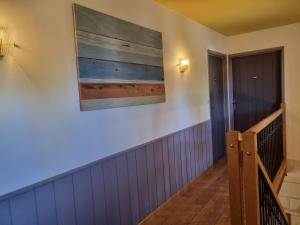 a hallway with stairs and a painting on the wall at Sirona - domaine viticole et chambres d'hôtes in Le Puy-Notre-Dame +25 photos