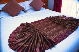 a large blanket on a bed in a bedroom at Golden Quest Hotel in Entebbe