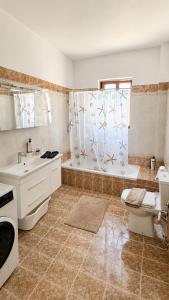 a bathroom with a tub and a toilet and a sink at Azure Seaside Living in Kardamaina +20 photos
