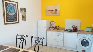 a kitchen with a white refrigerator and a washing machine at Casita Zagra in La Carrera de la Viña