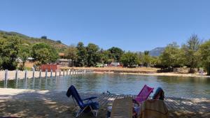 a group of chairs sitting next to a body of water at Cereza Home in Cabezuela del Valle