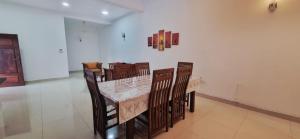 a dining room with a marble table and chairs at Cinnamon Villa Kandy in Kandy