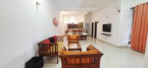 a living room with a couch and a dining room at Cinnamon Villa Kandy in Kandy