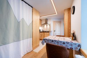 a small kitchen with a table in a room at Dolomitihouse NOGHERA in Fiera di Primiero +58 photos