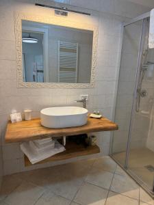 a bathroom with a sink and a shower at Dimora del Murattiano in Monopoli +5 photos