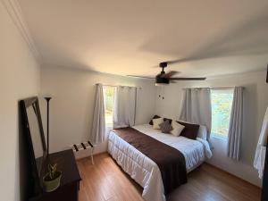 a bedroom with a bed and two windows at Magic Colombia in El Porvenir