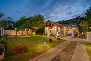 a house with a garden at night at Nature Trails Boutique Hotel in Unawatuna