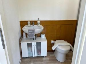 a bathroom with a sink and a toilet at Studio in Tramelan