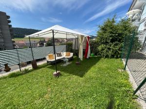 a gazebo in the yard of a house at Studio in Tramelan +3 photos