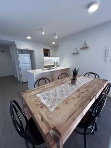 a wooden table in a kitchen with chairs around it at Location, location, location - private apartment in Brisbane