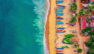 an overhead view of a beach with umbrellas and the ocean at Sandunes ReTreat Villa in Pondicherry