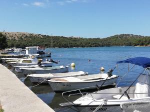 a bunch of boats are docked in the water at Slanraj Studio in Jadrtovac