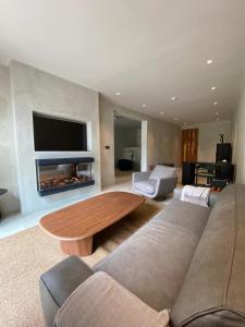 a living room with a couch and a coffee table at Ubucuti Gorilla Lodge in Kinigi
