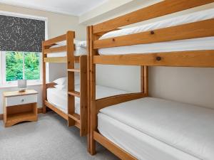 two bunk beds in a room with a window at Howgills Apartment 7 - Ukc9722 in Sedbergh