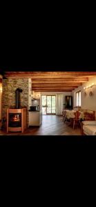 a living room with a fireplace and a dining room at Baita PUPILLE in Osteria Alpina