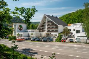 a large building with cars parked in a parking lot at Hotel Krainerhütte in Baden