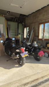 a motorcycle is parked in a garage at Studio Cozy, Vallée de la Saulx in Trémont-sur-Saulx