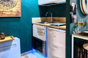 a kitchen with a sink and a dishwasher at JADE Hammam & Jacuzzi in Brie-Comte-Robert +8 photos