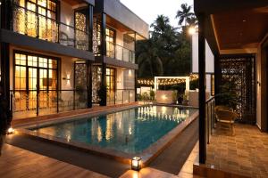 a swimming pool in the middle of a house at Barefoot bliss by iLiF Hotels in Revadanda
