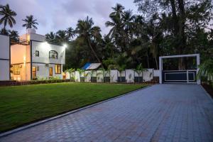 an exterior view of a house with a lawn at Barefoot bliss by iLiF Hotels in Revadanda