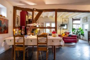 a dining room with a table and chairs at Op de Klever in Schimmert