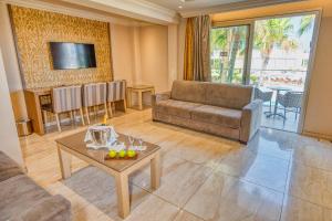 a living room with a couch and a table at Adams Beach Hotel & Spa in Ayia Napa