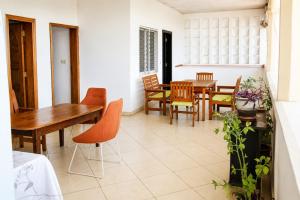 a dining room with a table and chairs at Chambre à louer in Moroni