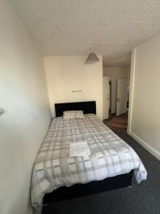 a bedroom with a bed with a checkered blanket at kinsale Central Rooms in Kinsale